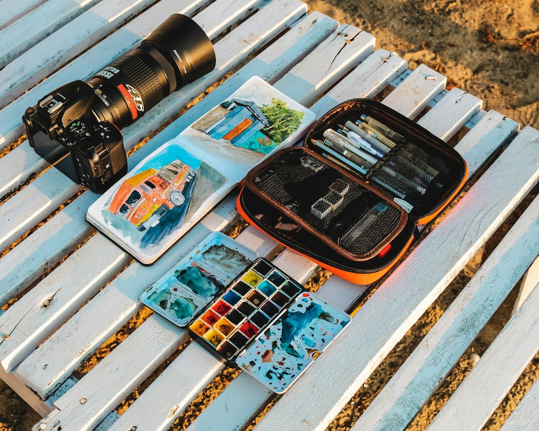 Travel planning flat lay with map, camera and passport on a table