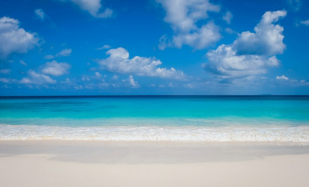 Tropical beach with turquoise water and white sand at sunrise
