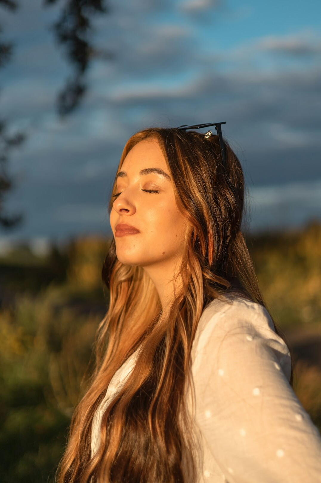 Portrait of a young Polish woman with long hair smiling outdoors