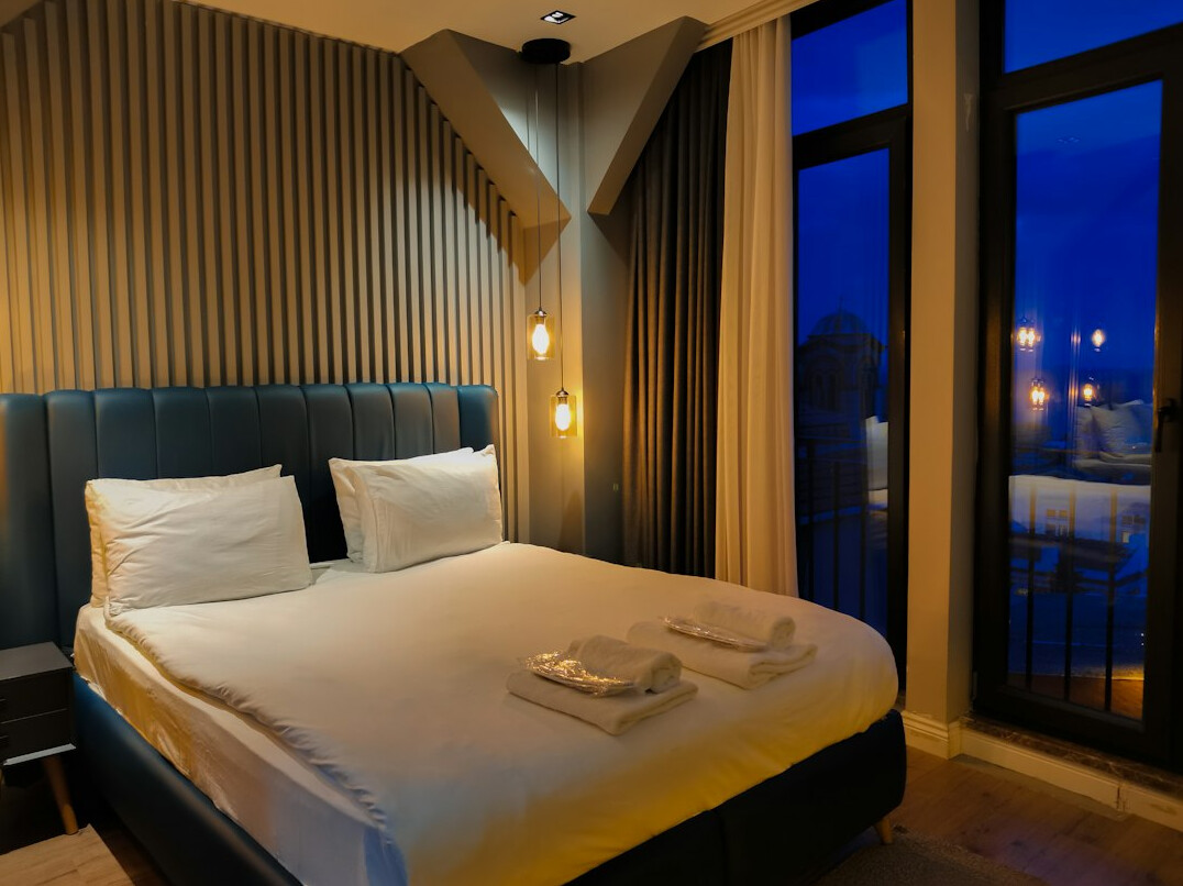 Bright and cozy hotel room with a double bed and large window